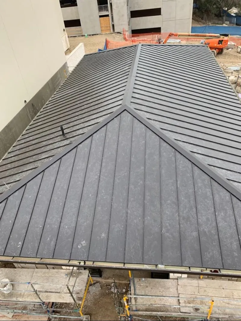 Commercial metal roof construction with crane equipment in Bushkill